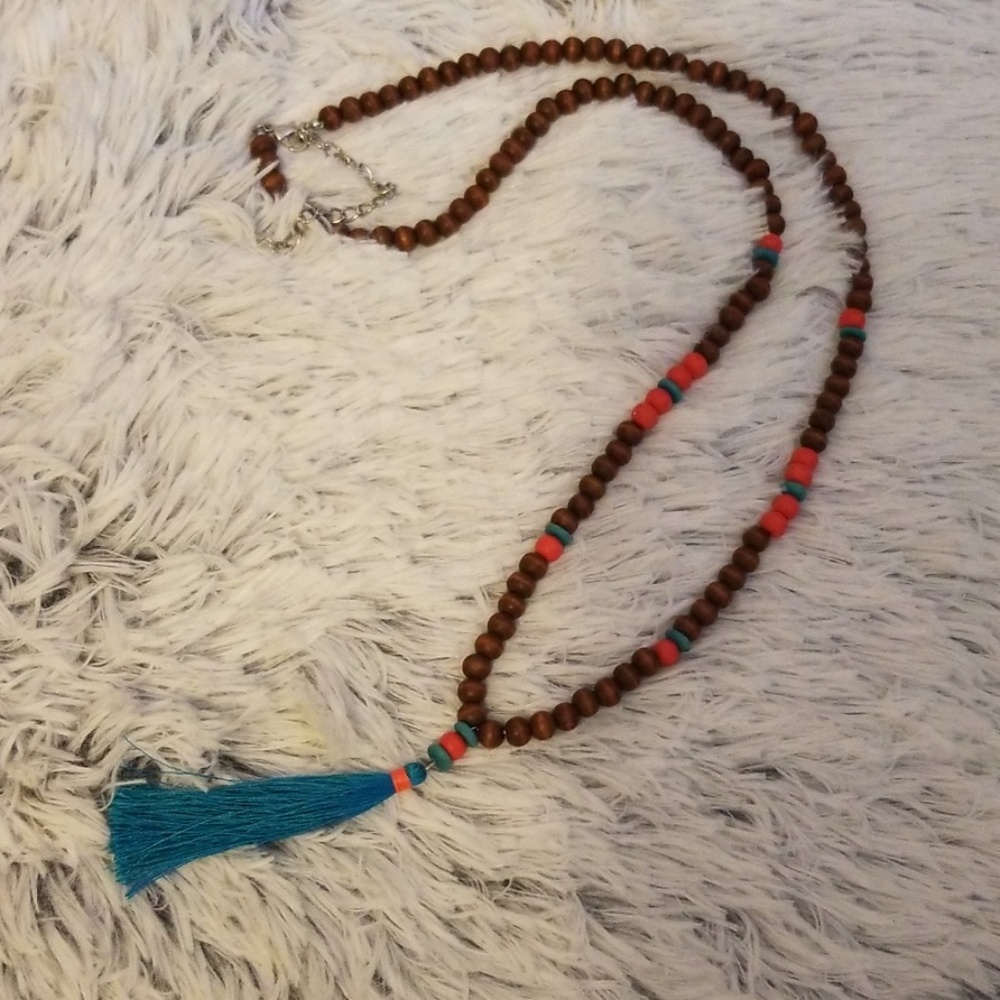 Long beaded necklace. Tan, coral, and blue